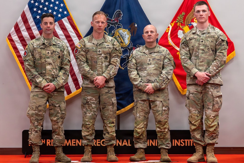 (Left to right) Sgt. 1st Class Ryan Herb, Sgt. 1st Class Erich Friedlein, Command Sgt. Maj. Oscar Laughman, and Spc. Peter Wenzel pose for a photo at the Pennsylvania Army National Guard State Best Warrior Competition awards ceremony April 12, 2026, at Fort Indiantown Gap, Pa. (Pennsylvania National Guard photo by Sgt. Tristan Murry)