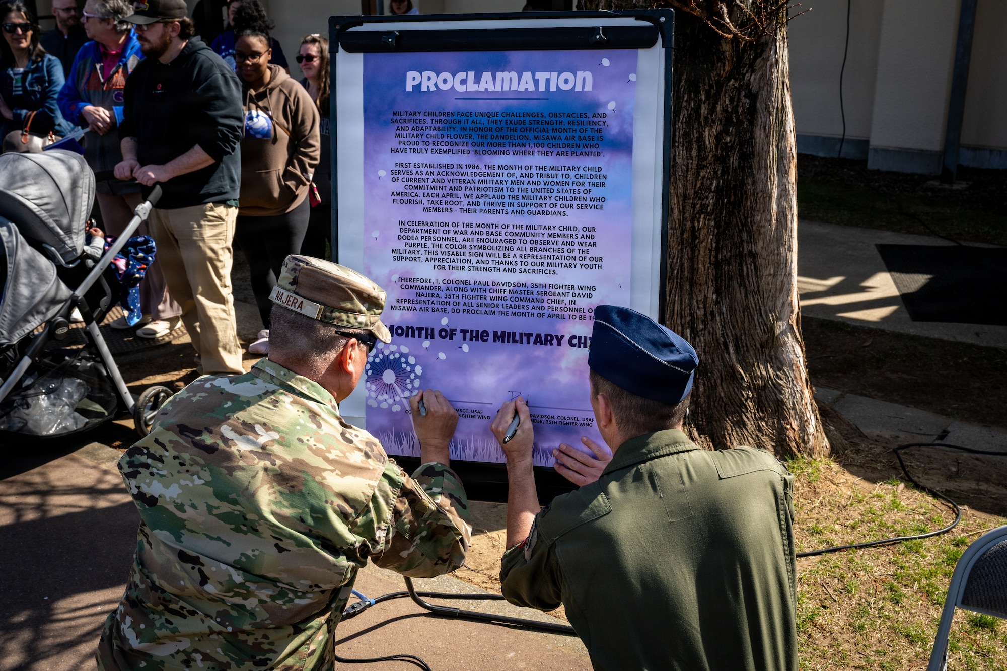U.S. Air Force Col. Matthew Hoyt, right, 35th Fighter Wing deputy commander, and Chief Master Sgt. David Najera, 35th Fighter Wing command chief, sign a proclamation to honor the Month of the Military Child at Misawa Air Base