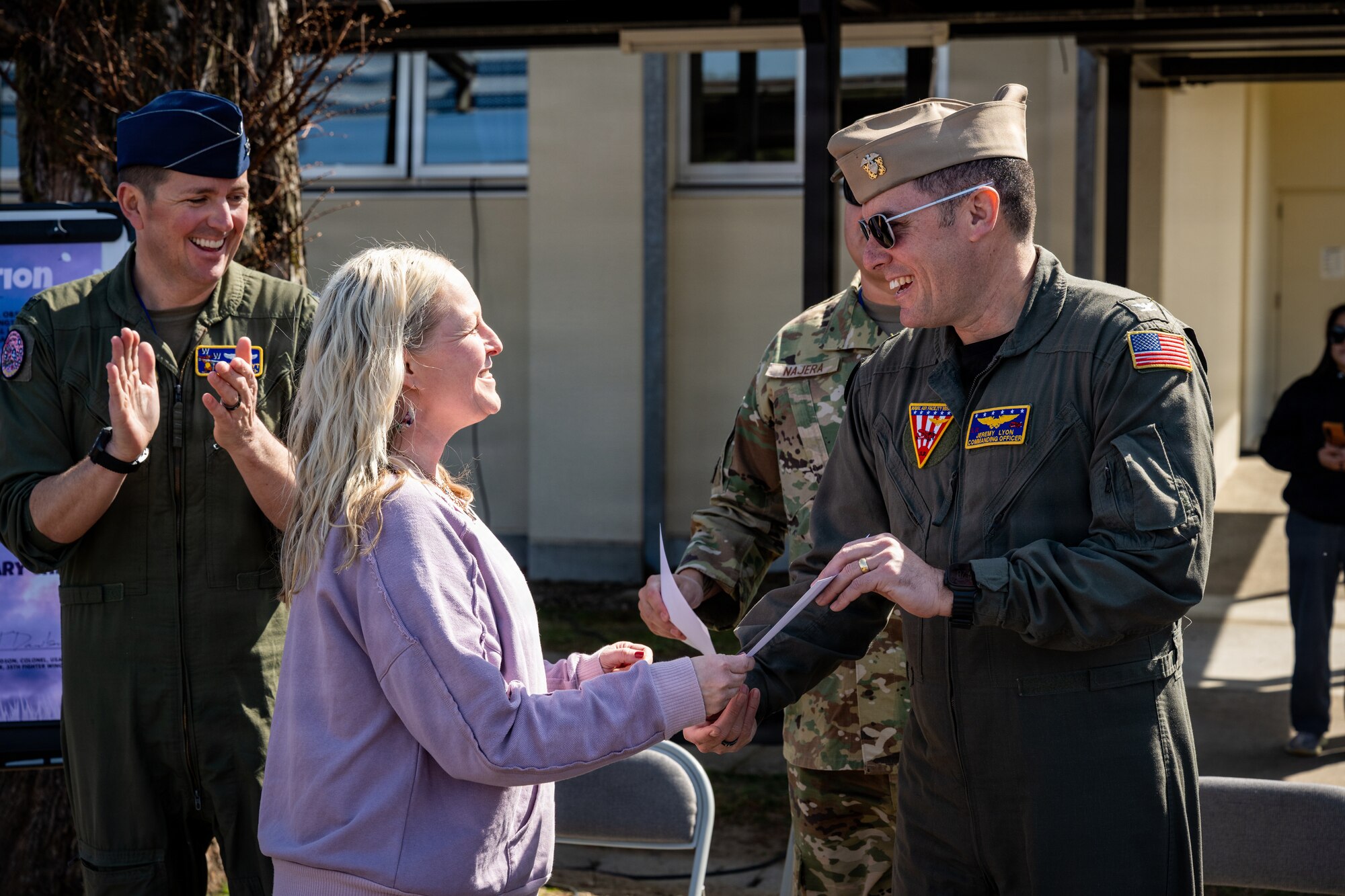 U.S. Navy Capt. Jeremy N. Lyon, Naval Air Facility Misawa commanding officer, presents a certificate of appreciation to a Sollars Elementary School teacher during the Month of the Military Child proclamation ceremony at Misawa Air Base, Japan, April 10, 2026.