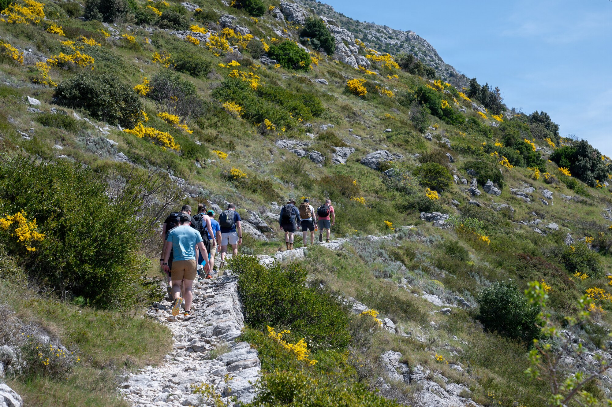 People hike up a mountain