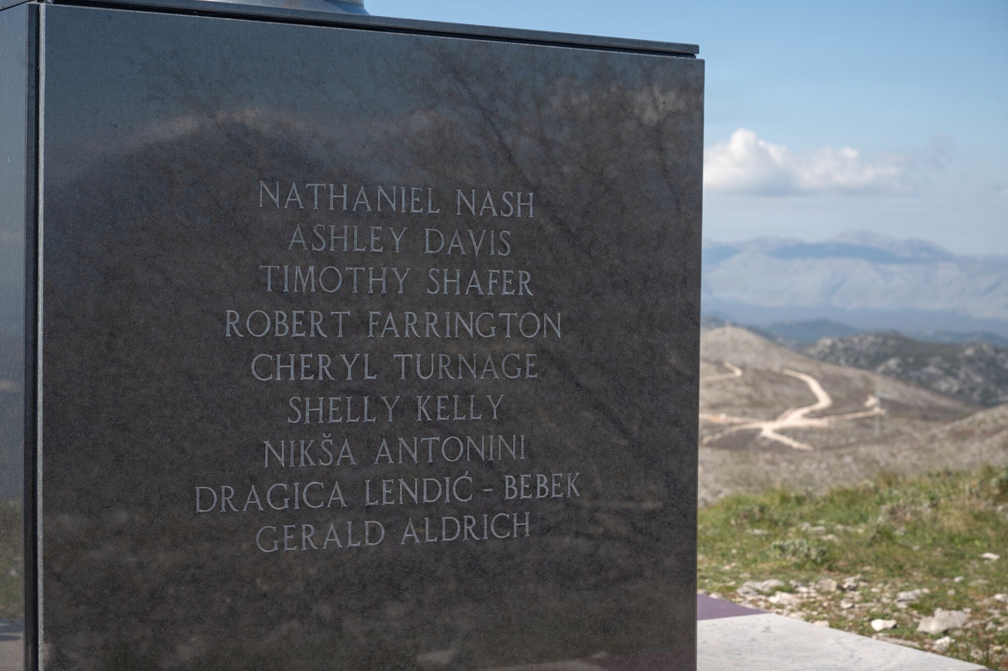A placard sits on a mountain