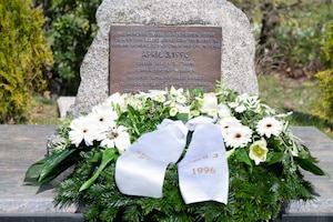 A wreath lays in front of a memorial