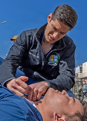 YOKOSUKA, Japan (March 11, 2026) — Lt. Cmdr. Caleb Town, a dental officer assigned to U.S. Naval Hospital (USNH) Yokosuka, performs simulated lifesaving measures on a casualty alongside Japan Maritime Self-Defense Force (JMSDF) responders during triage operations outside the hospital during a bilateral mass casualty drill. The training reinforced hands-on skills and teamwork under realistic conditions. USNH Yokosuka and Japan Self-Defense Force (JSDF) Hospital Yokosuka conducted the drill to enhance joint medical response capabilities and lifesaving procedures in support of a free and open Indo-Pacific. (U.S. Navy photo by Daniel Taylor/U.S. Naval Hospital Yokosuka Public Affairs)