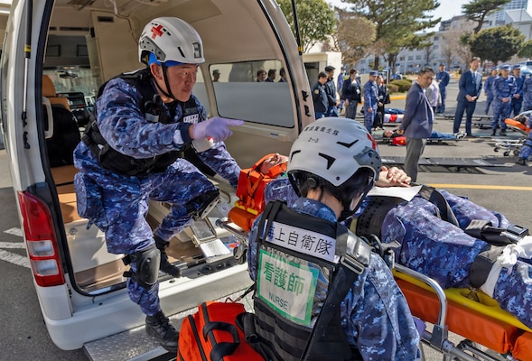 YOKOSUKA, Japan (March 11, 2026) — Japan Maritime Self-Defense Force (JMSDF) responders offload a simulated casualty from an ambulance during triage operations outside U.S. Naval Hospital (USNH) Yokosuka during a bilateral mass casualty drill. The scenario highlighted patient transport procedures and coordination between receiving and transferring teams. USNH Yokosuka and Japan Self-Defense Force (JSDF) Hospital Yokosuka conducted the drill to enhance joint medical response capabilities and lifesaving procedures in support of a free and open Indo-Pacific. (U.S. Navy photo by Daniel Taylor/U.S. Naval Hospital Yokosuka Public Affairs)