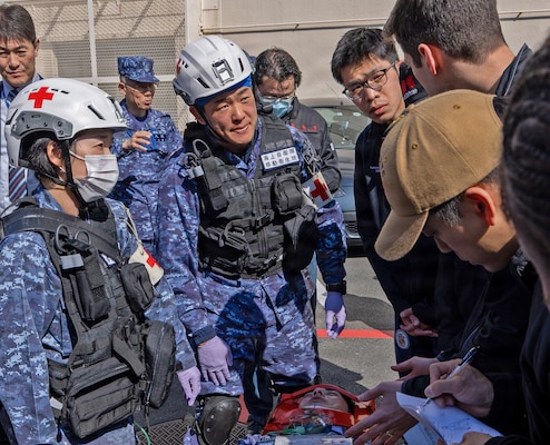 YOKOSUKA, Japan (March 11, 2026) — U.S. Naval Hospital (USNH) Yokosuka personnel and Japan Maritime Self-Defense Force (JMSDF) responders observe and assist during casualty movement operations outside USNH Yokosuka during a bilateral mass casualty drill. The training emphasized teamwork and interoperability in preparing patients for evacuation. USNH Yokosuka and Japan Self-Defense Force (JSDF) Hospital Yokosuka conducted the drill to enhance joint medical response capabilities and lifesaving procedures in support of a free and open Indo-Pacific. (U.S. Navy photo by Daniel Taylor/U.S. Naval Hospital Yokosuka Public Affairs)