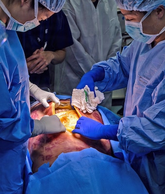 YOKOSUKA, Japan (March 11, 2026) — U.S. Naval Hospital (USNH) Yokosuka and Japan Self-Defense Force (JSDF) Hospital Yokosuka medical personnel conduct simulated surgical procedures using a “cut suit” training system during a bilateral mass casualty drill at USNH Yokosuka. The wearable simulator replicates complex trauma injuries, allowing teams to practice incision, hemorrhage control, and coordinated surgical response in a realistic environment. USNH Yokosuka and JSDF Hospital Yokosuka conducted the drill to enhance joint medical response capabilities and lifesaving procedures in support of a free and open Indo-Pacific. (U.S. Navy photo by Daniel Taylor/U.S. Naval Hospital Yokosuka Public Affairs)