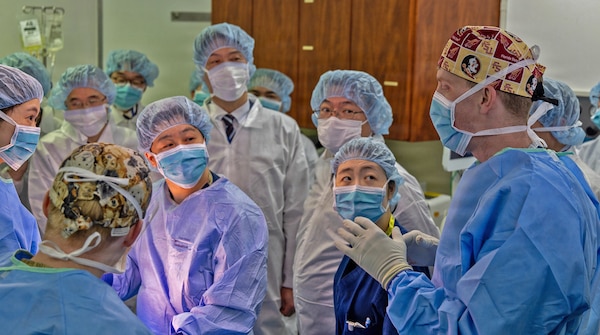 YOKOSUKA, Japan (March 11, 2026) — U.S. Naval Hospital (USNH) Yokosuka and Japan Self-Defense Force (JSDF) Hospital Yokosuka medical personnel conduct simulated surgical procedures using a “cut suit” training system during a bilateral mass casualty drill at USNH Yokosuka. The wearable simulator replicates complex trauma injuries, allowing teams to practice incision, hemorrhage control, and coordinated surgical response in a realistic environment. USNH Yokosuka and JSDF Hospital Yokosuka conducted the drill to enhance joint medical response capabilities and lifesaving procedures in support of a free and open Indo-Pacific. (U.S. Navy photo by Daniel Taylor/U.S. Naval Hospital Yokosuka Public Affairs)