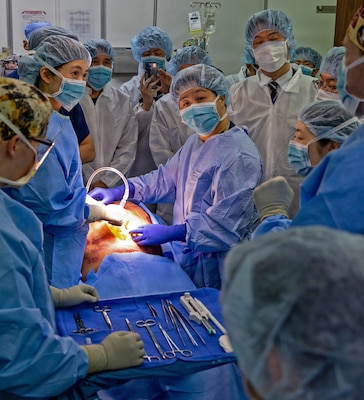 YOKOSUKA, Japan (March 11, 2026) — U.S. Naval Hospital (USNH) Yokosuka and Japan Self-Defense Force (JSDF) Hospital Yokosuka medical personnel conduct simulated surgical procedures using a “cut suit” training system during a bilateral mass casualty drill at USNH Yokosuka. The wearable simulator replicates complex trauma injuries, allowing teams to practice incision, hemorrhage control, and coordinated surgical response in a realistic environment. USNH Yokosuka and JSDF Hospital Yokosuka conducted the drill to enhance joint medical response capabilities and lifesaving procedures in support of a free and open Indo-Pacific. (U.S. Navy photo by Daniel Taylor/U.S. Naval Hospital Yokosuka Public Affairs)