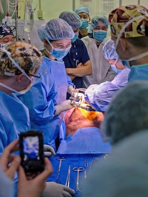 YOKOSUKA, Japan (March 11, 2026) — U.S. Naval Hospital (USNH) Yokosuka and Japan Self-Defense Force (JSDF) Hospital Yokosuka medical personnel conduct simulated surgical procedures using a “cut suit” training system during a bilateral mass casualty drill at USNH Yokosuka. The wearable simulator replicates complex trauma injuries, allowing teams to practice incision, hemorrhage control, and coordinated surgical response in a realistic environment. USNH Yokosuka and JSDF Hospital Yokosuka conducted the drill to enhance joint medical response capabilities and lifesaving procedures in support of a free and open Indo-Pacific. (U.S. Navy photo by Daniel Taylor/U.S. Naval Hospital Yokosuka Public Affairs)