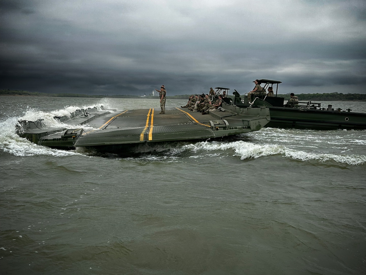 U.S. Army Reserve Soldiers from the 401st Engineer Company conduct multi-role bridging training operations at Bardwell Lake in Texas. The exercise focuses on wet gap crossing techniques, including ribbon bridge and raft operations, enabling the transport of vehicles, equipment, and personnel across water obstacles. The training integrates new Soldiers fresh from Advanced Individual Training (AIT) alongside experienced Noncommissioned Officers, enhancing readiness, morale, and technical proficiency. Conducted in partnership with the U.S. Army Corps of Engineers (USACE), the field training exercise highlights the importance of interagency collaboration and access to USACE-managed resources for realistic, mission-essential training environments.