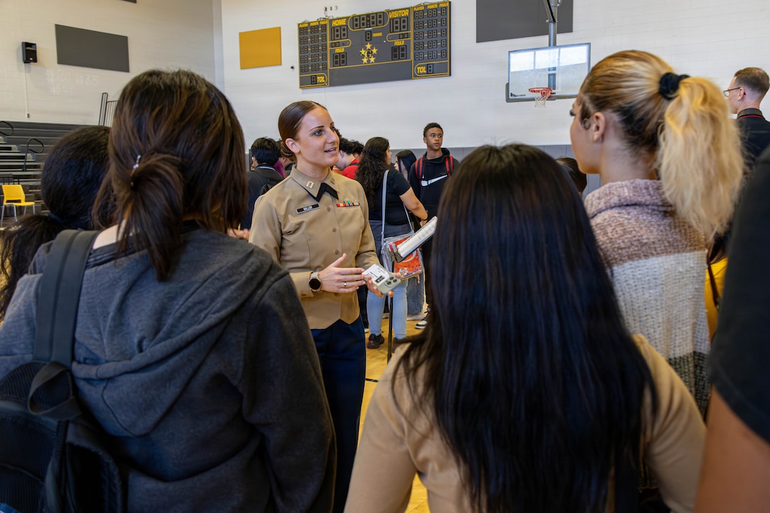 U.S. Marine Corps Capt. Maddison Millier, executive officer for Marine Recruiting Station South Texas, 8th Marine Corps District, speaks to students at Margaret Long Wisdom High School in Houston, Texas, March 2, 2026. The performance was in conjunction with school visits to engage with students and highlight career opportunities in the Marine Corps band. (U.S. Marine Corps photo by Cpl. Christian Salazar)