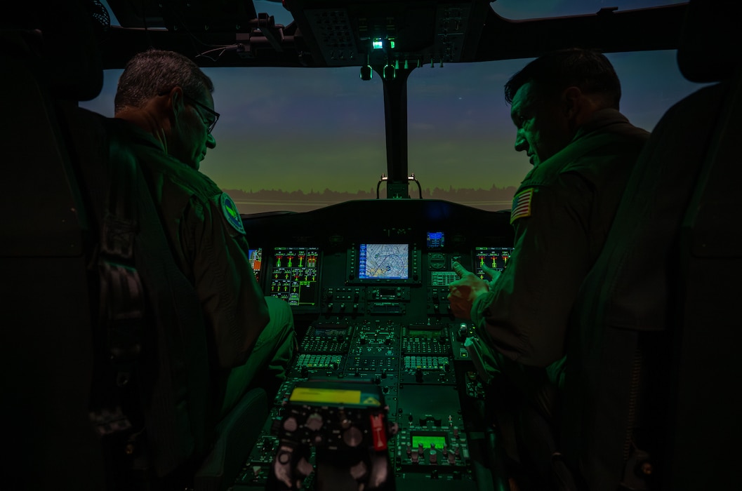 Two people use a simulator