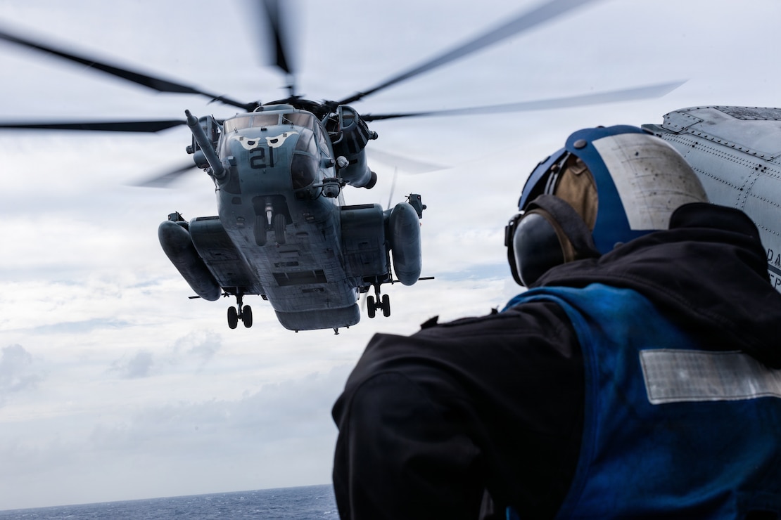 A CH-53E Super Stallion assigned to Marine Medium Tiltrotor Squadron (VMM) 163 (Reinforced), 11th Marine Expeditionary Unit, hovers over the flight deck of San Antonio-class amphibious transport dock ship USS Portland (LPD 27), during flight operations in the Pacific Ocean, April 10, 2026. The 11th MEU, embarked aboard the Boxer Amphibious Ready Group, is a persistent, combat credible force contributing to deterrence and crisis response in the U.S. 7th Fleet area of operations. U.S. 7th Fleet, the U.S. Navy’s largest forward-deployed numbered fleet, routinely interacts and operates with allies and partners to preserve a free and open Indo-Pacific. (U.S. Marine Corps photo by Lance Cpl. Luke Rodriguez)