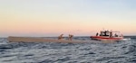 A third-generation long range interceptor (LRI III) cutter boat remains on scene after disrupting a low-profile smuggling vessel.