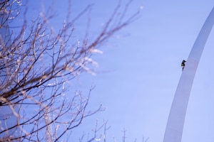 A contractor scales the U.S. Air Force Memorial during a periodic cleaning operation in Arlington, Va., March 24, 2026. Completed in 2006, the memorial undergoes cleaning and inspection every five years. (U.S. Air Force photo by Airman 1st Class Brandon Thomas)