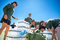 People stacking packaged water