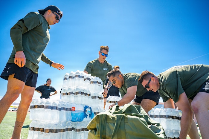People stacking packaged water