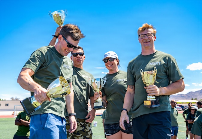 People standing with trophies