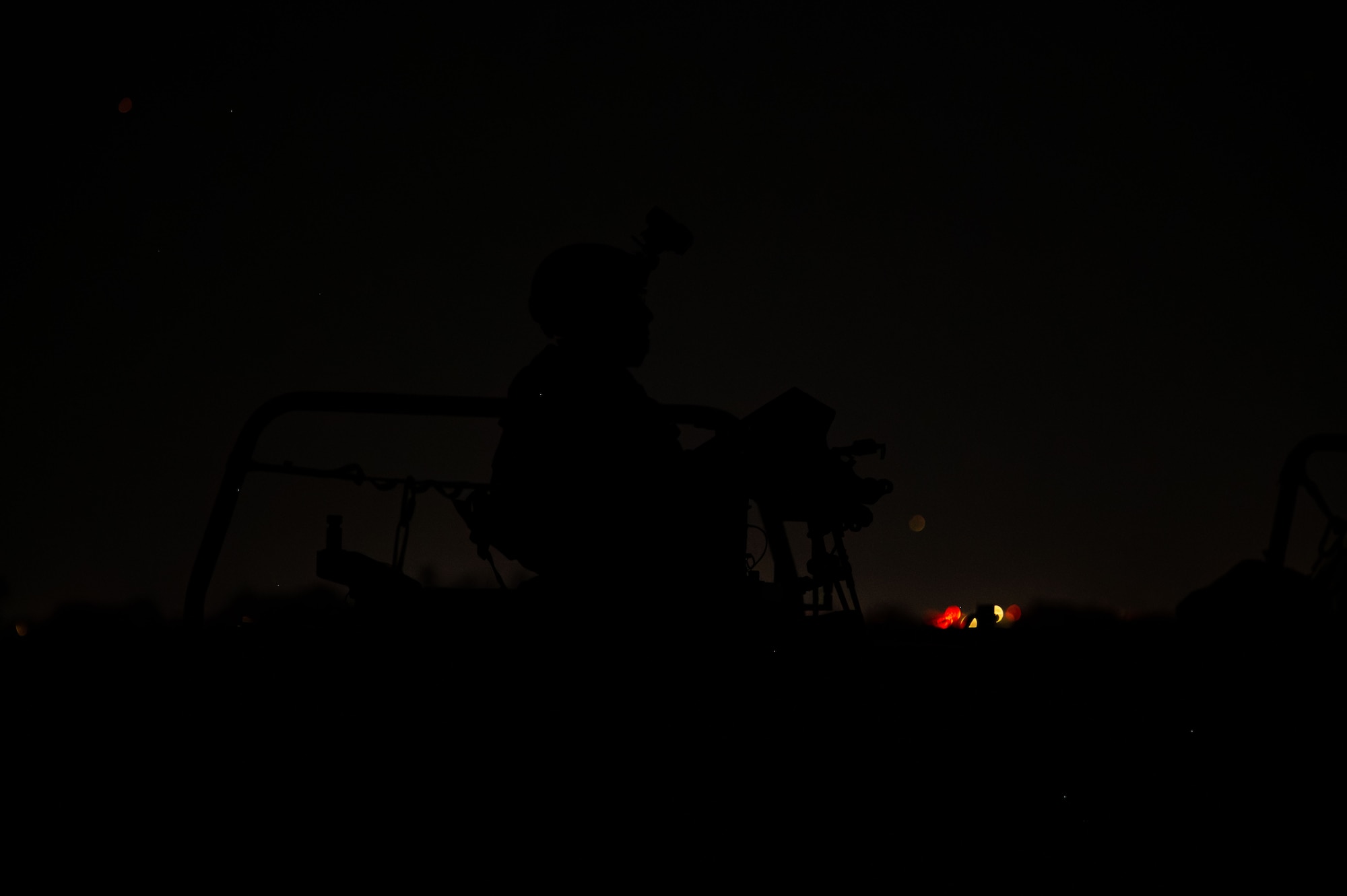 A U.S. Air Force pararescueman assigned to the 68th Rescue Squadron stands guard during the Combat Leader Course  at Davis-Monthan Air Force Base, Arizona, April 10, 2026. The course places pararescuemen in realistic, high-stress situations to strengthen decision-making during rescue missions. (U.S. Air Force photo by Airman 1st Class Jaden Kidd)