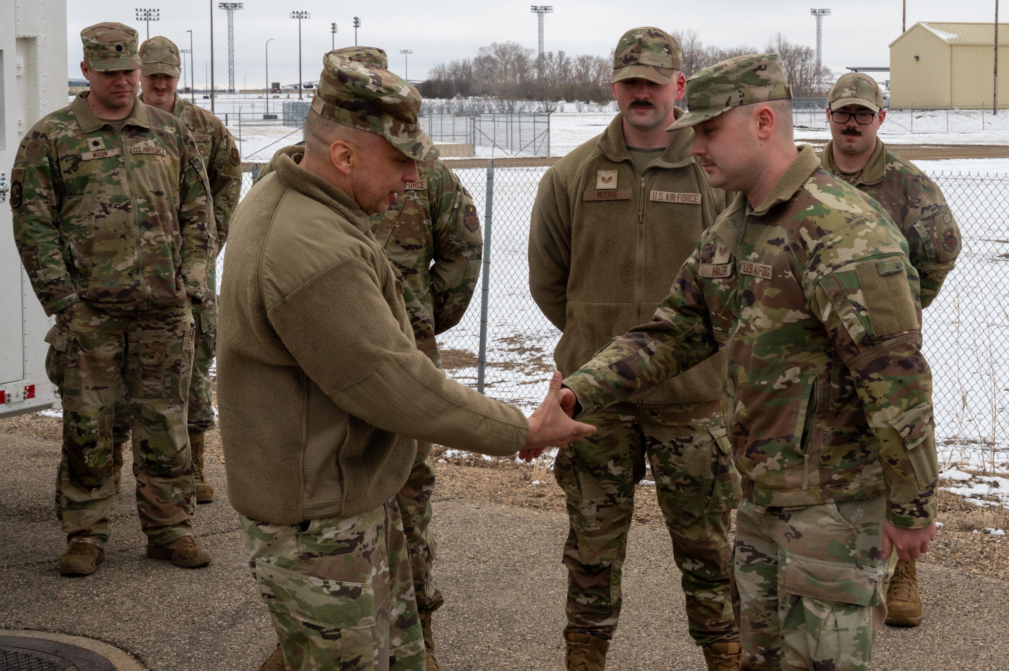 U.S. Air Force Maj. Gen. Lyle Drew, director Defense Threat Reduction Agency (DTRA), coins U.S. Air Force Staff Sgt. Caleb Haler, assigned to the 373rd Training Readiness Squadron Detachment 23 at Minot Air Force Base, North Dakota, March 30, 2026. DTRA is a combat support agency within the U.S. Department of Defense focused on countering and deterring weapons of mass destruction.