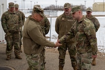 U.S. Air Force Maj. Gen. Lyle Drew, director Defense Threat Reduction Agency (DTRA), coins U.S. Air Force Staff Sgt. Caleb Haler, assigned to the 373rd Training Readiness Squadron Detachment 23 at Minot Air Force Base, North Dakota, March 30, 2026. DTRA is a combat support agency within the U.S. Department of Defense focused on countering and deterring weapons of mass destruction.