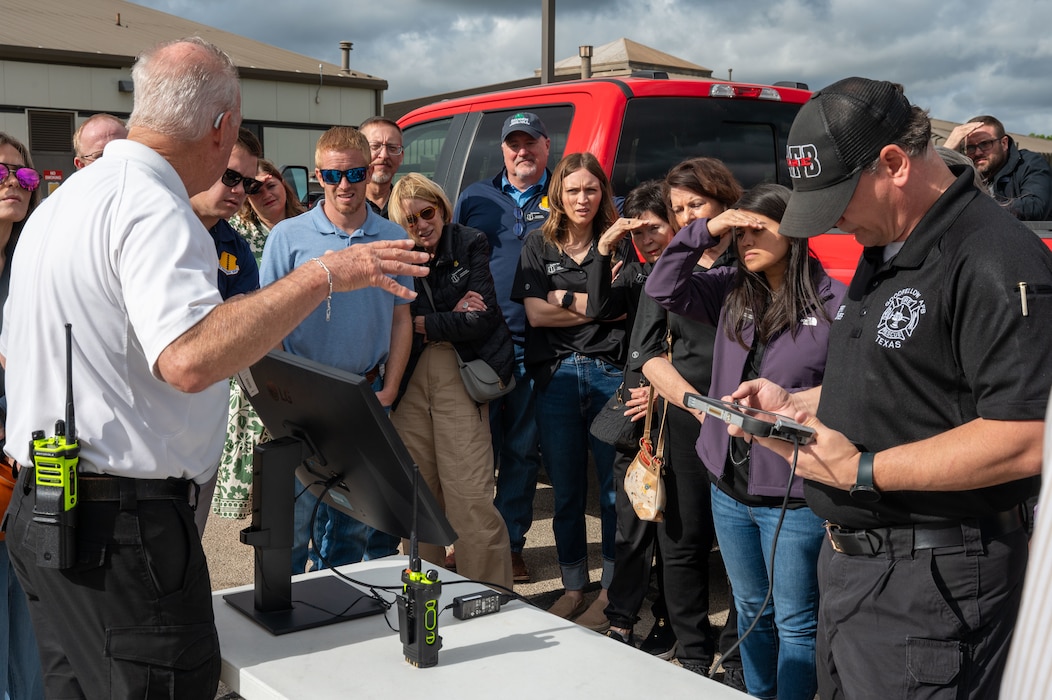 Members of the Goodfellow Fire Department brief honorary commanders while displaying a live drone camera feed during the 17th Mission Support Group immersion at Goodfellow Air Force Base, Texas, April 9, 2026. The demonstration highlighted how aerial imagery supports emergency management and response efforts. (U.S. Air Force photo by Senior Airman James Salellas)