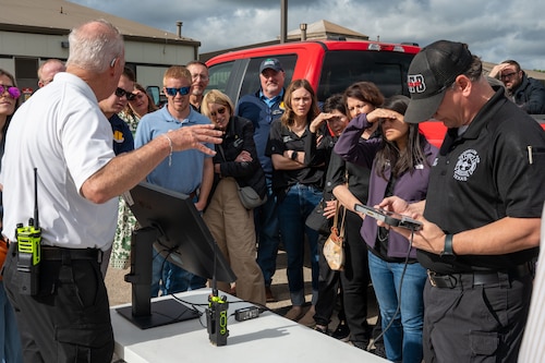 Members of the Goodfellow Fire Department brief honorary commanders while displaying a live drone camera feed during the 17th Mission Support Group immersion at Goodfellow Air Force Base, Texas, April 9, 2026. The demonstration highlighted how aerial imagery supports emergency management and response efforts. (U.S. Air Force photo by Senior Airman James Salellas)