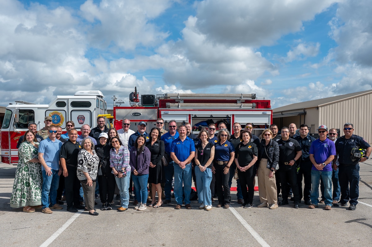 Honorary commanders pose for a photo in front of a fire department vehicle following a tour of the 17th Civil Engineer Squadron during the 17th Mission Support Group immersion at Goodfellow Air Force Base, Texas, April 9, 2026. The visit highlighted emergency response capabilities and infrastructure support across the installation. (U.S. Air Force photo by Senior Airman James Salellas)