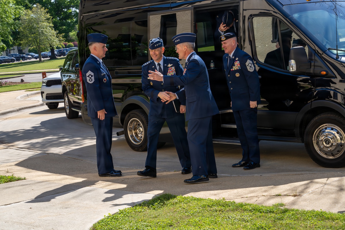 Gen. Ken Wilsbach, Air Force Chief of Staff, center, and Chief Master Sgt. of the Air Force David R. Wolfe, right, are greeted by Lt. Gen. Daniel Tulley, commander and president of Air University, upon arrival at Air University headquarters at Maxwell Air Force Base, Alabama, April 9, 2026.