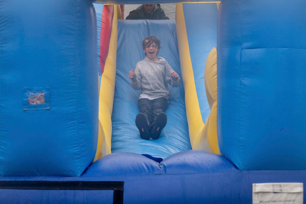 A Scout slides down an inflatable obstacle course during the 2026 Scout Expo at Beale Air Force Base, California, April 11, 2026.