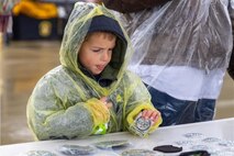 A Scout considers memorabilia offered at the 2026 Scout Expo at Beale Air Force Base, California, April 11, 2026.