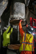 Navy Closure Task Force-Red Hill (NCTF-RH) contractors seal a shaft after spool removal prior to tank degassing operations at the Red Hill Bulk Fuel Storage Facility (RHBFSF) in Honolulu, March 17, 2026. Degassing, or forced ventilation, of the underground storage tanks and subsequent air monitoring procedures have undergone rigorous modeling and regulatory scrutiny to ensure the safety of the surrounding community while allowing workers to safely enter and clean the interior of the tanks. Charged with the safe decommissioning of the RHBFSF, NCTF-RH was established by the Department of the Navy as a commitment to the community and the environment. NCTF-RH continues to engage with the people of Hawaii, regulatory agencies, and other stakeholders as it safely and deliberately decommissions the facility. (U.S. Navy photo by Mass Communication Specialist 2nd Class Krystal Diaz)