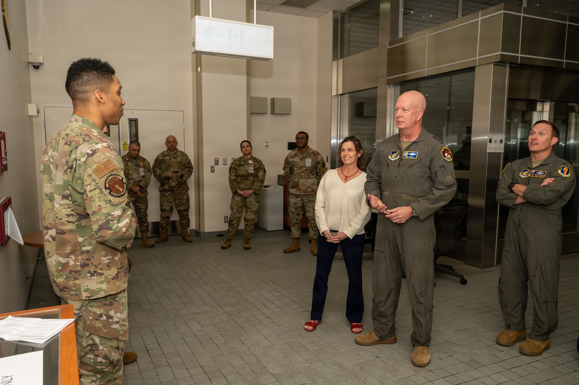 A U.S. Airman assigned to the 35th Medical Support Squadron (MDSS) briefs U.S. Air Force Lt. Gen. Joel Carey, Fifth Air Force commander, and his wife Mendy Carey during an immersion tour.