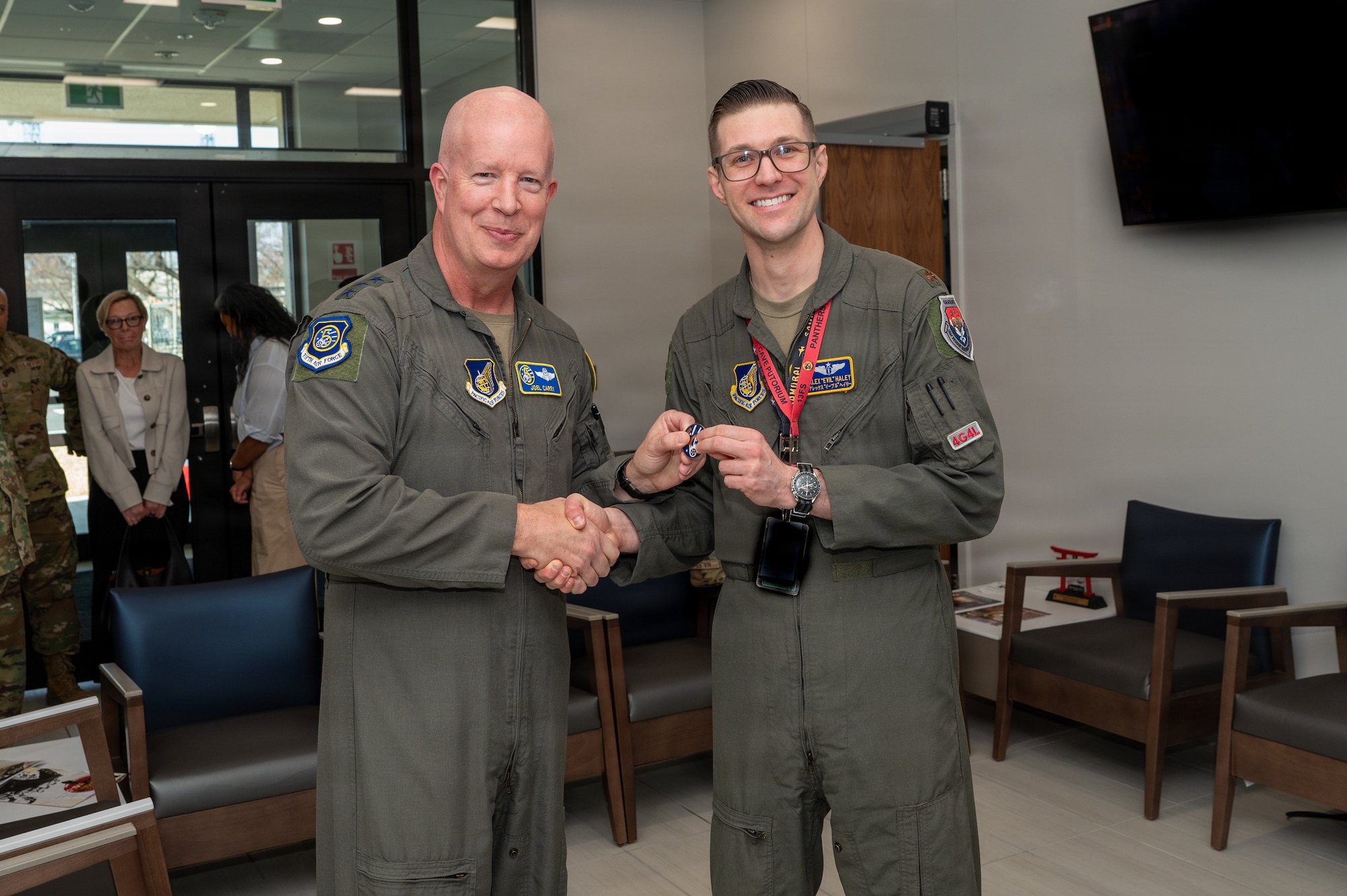 U.S. Air Force Lt. Gen. Joel Carey, Fifth Air Force commander, poses for a photo after coining Maj. Alexander Haley, 35th Medical Group chief of aerospace medicine, during an immersion tour.