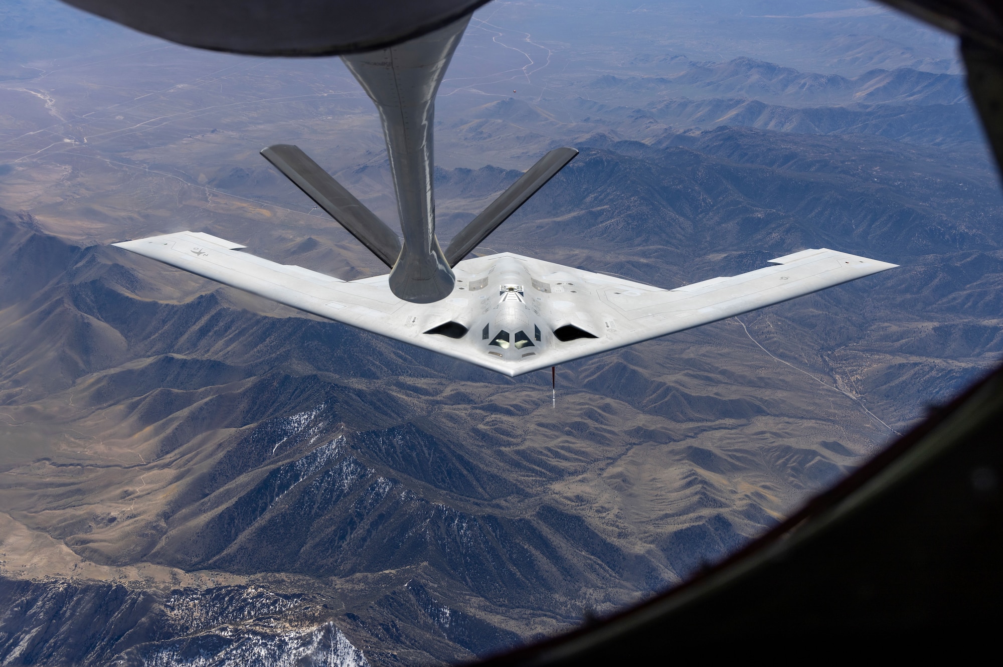 A U.S. Air Force B-21 Raider conducts aerial refueling with a KC-135 Stratotanker. The B-21 program exemplifies the Department of the Air Force's warfighting-focused acquisition mindset, leveraging digital engineering and modern production to deliver a mature, highly capable system at speed. The B-21's efficiency and flexibility will provide a survivable, unpredictable deterrent force, forming the backbone of America’s future bomber force.  (U.S. Air Force photo)