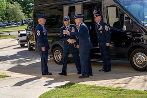Gen. Ken Wilsbach, Air Force Chief of Staff, center, and Chief Master Sgt. of the Air Force David R. Wolfe, right, are greeted by Lt. Gen. Daniel Tulley, commander and president of Air University, upon arrival at Air University headquarters at Maxwell Air Force Base, Alabama, April 9, 2026.