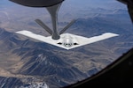 A U.S. Air Force B-21 Raider conducts aerial refueling with a KC-135 Stratotanker. The B-21 program exemplifies the Department of the Air Force's warfighting-focused acquisition mindset, leveraging digital engineering and modern production to deliver a mature, highly capable system at speed. The B-21's efficiency and flexibility will provide a survivable, unpredictable deterrent force, forming the backbone of America’s future bomber force.  (U.S. Air Force photo)