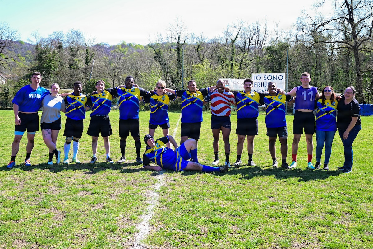 Rugby players pose for a photo.