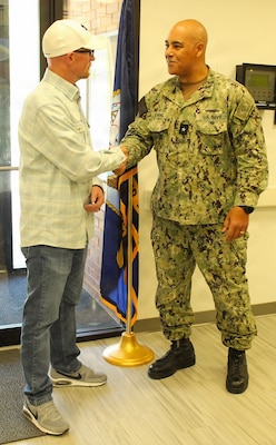 INDIAN HEAD, Md. – Mr. Tommy Eno, Facilities Manager for Naval Health Clinic Patuxent River, was recognized for his diligent efforts and consistent focus on maintaining the environment of care. Mr. Eno's resourcefulness and dedication to the patient care mission across three geographically distributed sites demonstrate his impressive ability to achieve excellence in a fiscally constrained environment. In recognition of his vital contributions, Rear Adm. Reginald Ewing, III, director, Defense Health Agency-National Capital Region, presented him with a coin. Mr. Eno is consistently trusted by the command to go above and beyond in improving working conditions and ensuring a safe environment for patients and staff.