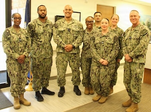 INDIAN HEAD, Md. – Rear Adm. Reginald Ewing, III, Director, Defense Health Agency-National Capital Region, stands with leadership from Naval Branch Health Clinic (NBHC) Indian Head and its parent command, Naval Health Clinic Patuxent River, during a visit to the facility. Pictured from left to right are: Capt. Teresita Alston, Chief Petty Officer Jaygould Keller, Rear Adm. Reginald Ewing, III., Cmdr. Jennifer Williams, Senior Chief Petty Officer Raymond Pomida, Lt. Patricia Baker, Chief Petty Officer Amber Ronquille, and Capt. Ken Radford.