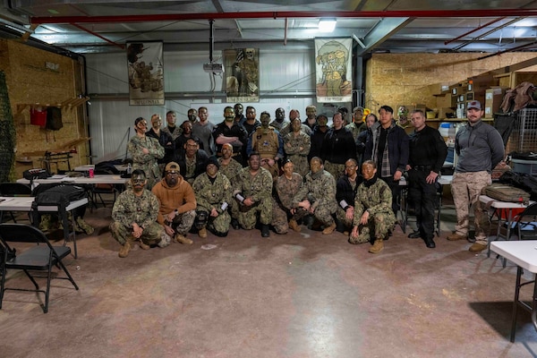 260212-N-JC800-1001 BETHESDA, Md. (Feb. 12, 2026) - Students and instructors pose for a photo during a final exercise as part of the Tactical Combat Casualty Course. (U.S. Navy Photo by Mass Communication Specialist 1st Class Heath Zeigler/Released)