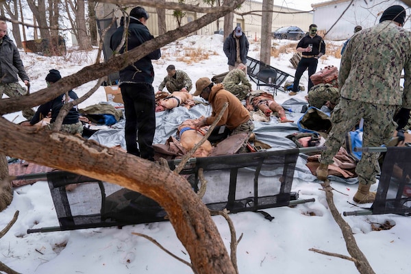260212-N-JC800-1009 BETHESDA, Md. (Feb. 12, 2026) - Students perform simulated medical practices as part of the final exercise for the Tactical Combat Casualty Course. (U.S. Navy Photo by Mass Communication Specialist 1st Class Heath Zeigler/Released)