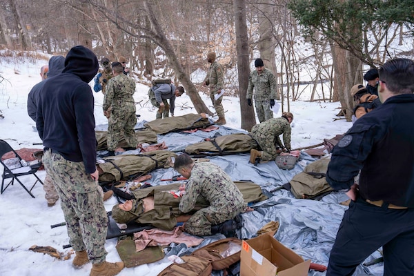 260212-N-JC800-1016 BETHESDA, Md. (Feb. 12, 2026) - Students prepare their simulated casualties for transport during a final exercise as part of the Tactical Combat Casualty Course. (U.S. Navy Photo by Mass Communication Specialist 1st Class Heath Zeigler/Released)