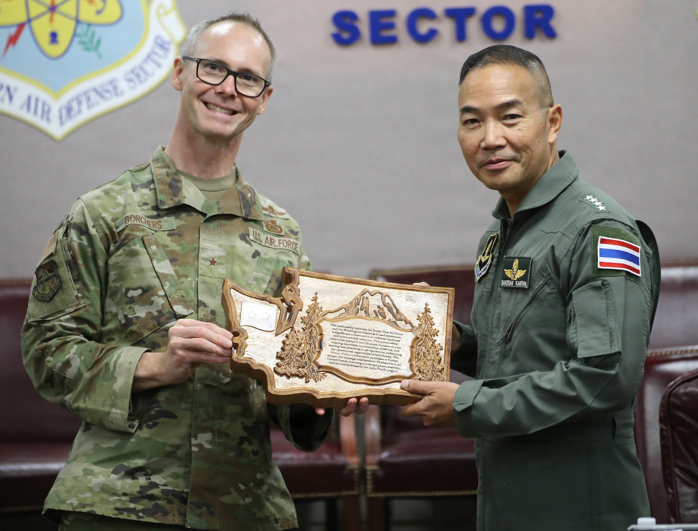 Brig. Gen. Ken Borchers, Commander, Washington Air National Guard and Assistant Adjutant General, Washington National Guard, presents gifts to Air Chief Marshal Sakesan Kantha, Commander-in-Chief, Royal Thai Air Force, during a visit to Joint Base Lewis-McChord, Wash., April 13, 2026.