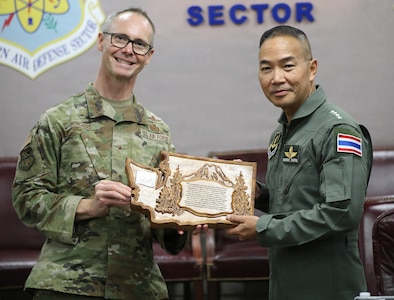 Brig. Gen. Ken Borchers, Commander, Washington Air National Guard and Assistant Adjutant General, Washington National Guard, presents gifts to Air Chief Marshal Sakesan Kantha, Commander-in-Chief, Royal Thai Air Force, during a visit to Joint Base Lewis-McChord, Wash., April 13, 2026.