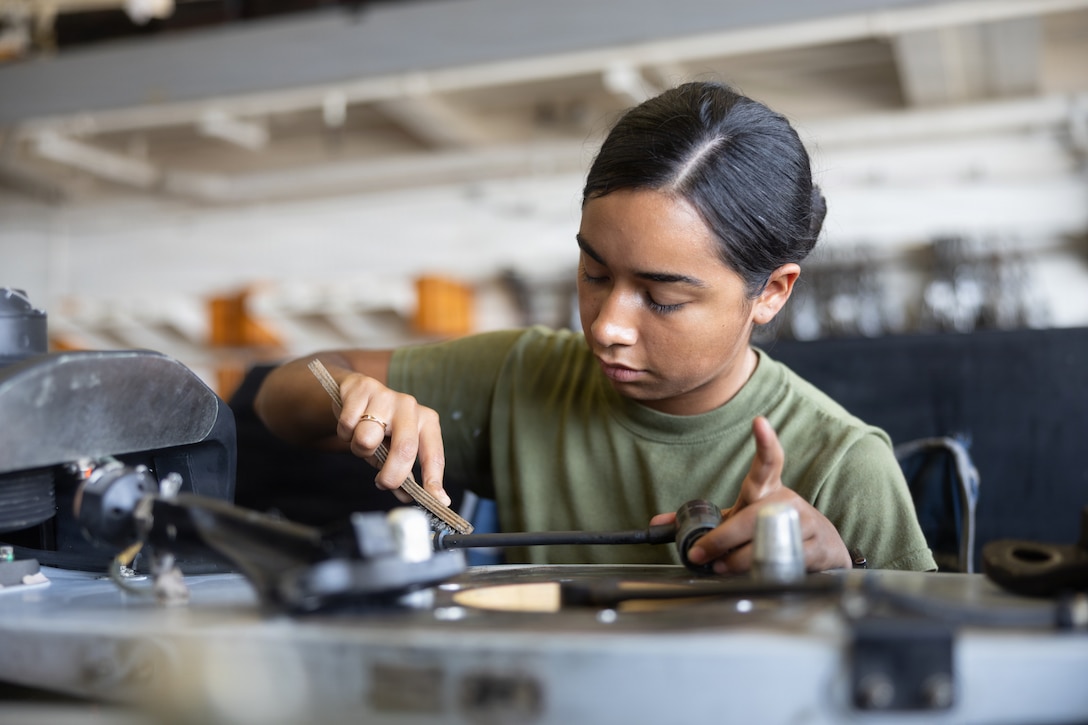 A U.S. Marine with Marine Medium Tiltrotor Squadron (VMM) 263 (Reinforced), 22nd Marine Expeditionary Unit (Special Operations Capable), cleans corrosion during maintenance on an AH-1Z Viper helicopter aboard San Antonio-class amphibious transport dock USS Fort Lauderdale (LPD 28), while underway in the Caribbean Sea, April 2, 2026. U.S. military forces are deployed to the Caribbean in support of the U.S. Southern Command mission, Department of War-directed operations, and the president’s priorities to disrupt illicit drug trafficking and protect the homeland. (U.S. Marine Corps photo)