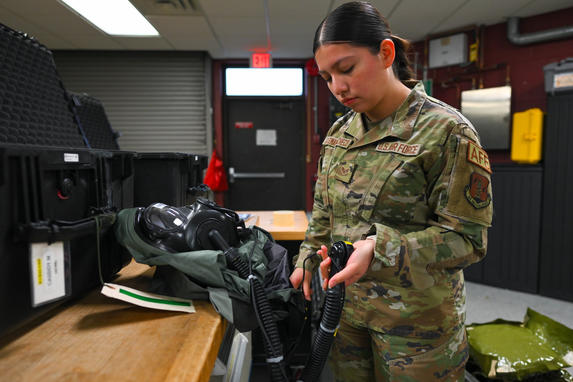 Senior Airman Jazmin Guzman Pacheco inspects equipment for flight crew.