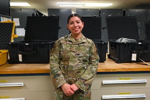 Senior Airman Jazmin Guzman Pacheco poses for a photo in the aircrew flight equipment room.