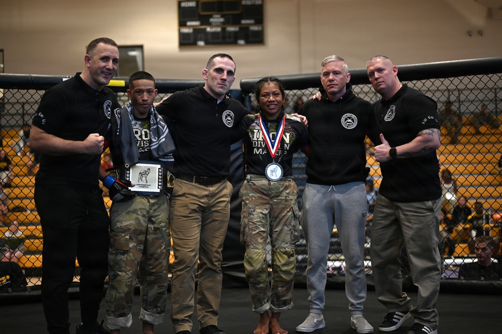 U.S. Army Spc. Isaiah Castellanos (2nd from left), District of Columbia National Guard, and Spc. Sandra Chheng, Pennsylvania Army National Guard, compete in the bantamweight finals during day three of the 2026 Lacerda Cup All-Army Combatives Championship at Fort Benning, Ga. Apr. 10, 2026. The two Army National Guard teams finished the tournament with third and sixth place team standings out of twenty-one teams competing, with three National Guard Soldiers earning championship belts.