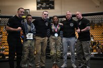 U.S. Army Spc. Isaiah Castellanos (2nd from left), District of Columbia National Guard, and Spc. Sandra Chheng, Pennsylvania Army National Guard, compete in the bantamweight finals during day three of the 2026 Lacerda Cup All-Army Combatives Championship at Fort Benning, Ga. Apr. 10, 2026. The two Army National Guard teams finished the tournament with third and sixth place team standings out of twenty-one teams competing, with three National Guard Soldiers earning championship belts.